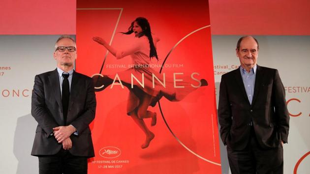Cannes Film festival general delegate Thierry Fremaux (L) and Cannes Film festival president Pierre Lescure (R) pose in front of the official poster for the 70th Cannes Film Festival after a news conference, to announce this year's official selection in Paris, France, April 13, 2017.(REUTERS)