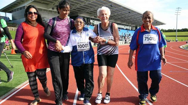 In truth her dash became more of a gentle amble the closer the tiny centenarian came to the finish line, with more energy spent beaming at spectators than running. (Michael Bradley/AFP)