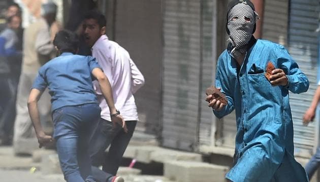 Kashmiri protesters clash with the forces after Friday prayers in Srinagar on April 21.(AFP)