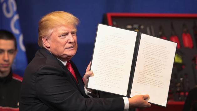 President Donald Trump signs an executive order to try to bring jobs back to American workers and revamp the H-1B visa guest worker program during a visit to the headquarters of tool manufacturer Snap-On on April 18, 2017 in Kenosha, Wisconsin.(AFP Photo) President Donald Trump signs an executive order to try to bring jobs back to American workers and revamp the H-1B visa guest worker program during a visit to the headquarters of tool manufacturer Snap-On on April 18, 2017 in Kenosha, Wisconsin.(AFP Photo)