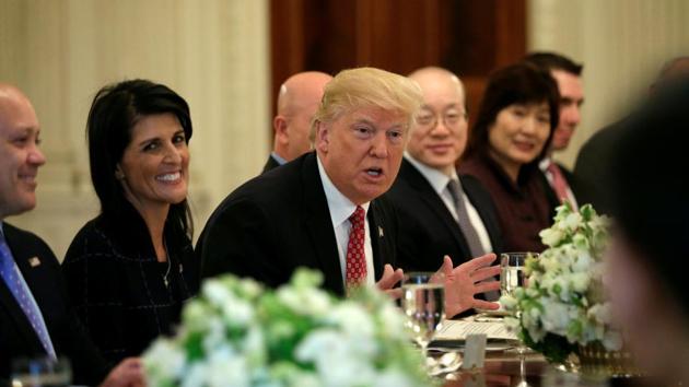 With US Ambassador to the United Nations Nikki Haley at his side (left), US President Donald Trump hosts a working lunch with ambassadors of countries on the UN Security Council at the White House in Washington on Monday.(REUTERS)