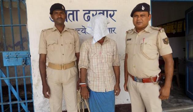 Mangal Sharma (face covered), an accused in the killing of his two-year-old son, with cops in Purnia. (Photo courtesy Abadhesh Roy/Hindustan) Mangal Sharma (face covered), an accused in the killing of his two-year-old son, with cops in Purnia. (Photo courtesy Abadhesh Roy/Hindustan)