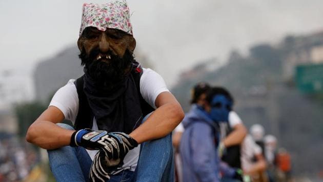 A demonstrator uses a mask during the rally. Maduro won the 2013 election by a narrow margin over opposition candidate Henrique Capriles. But Maduro’s popularity has since dropped. (Carlos Garcia Rawlins/REUTERS) A demonstrator uses a mask during the rally. Maduro won the 2013 election by a narrow margin over opposition candidate Henrique Capriles. But Maduro’s popularity has since dropped. (Carlos Garcia Rawlins/REUTERS)