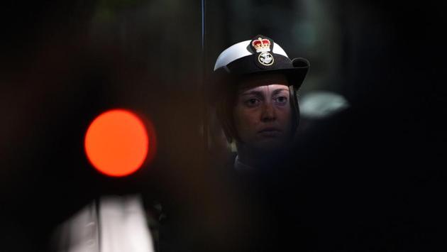 A servicewoman observes a minute of silence at the Dawn Service of Anzac Day in Sydney. (Saeed Khan/AFP)