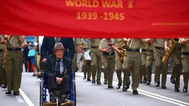 A veteran sits in a wheelchair as he participates in the annual ANZAC Day march. In Canberra, indigenous veterans -- who had to fight to be recognised for their sacrifices -- led the national march for the first time. (David Gray/REUTERS)