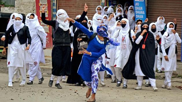 Girl students pelt stones at security personnel during clashes in Lal Chowk in Srinagar.(PTI)
