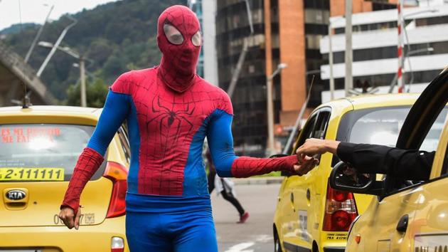Duque, who use public space without authorization, has practised circus art for nine years but only three years ago he came up with the ‘Arachnid’ costume. (Raul Arboleda / AFP)