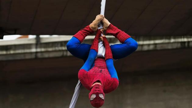 Colombian Jahn Fredy Duque, dressed as superhero ‘Spiderman’ hangs upside down on the streets in Bogota. (RAUL ARBOLEDA / AFP)