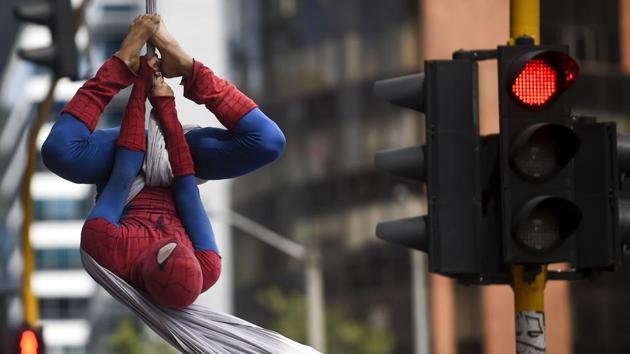 Dressed in red and blue is not Peter Parker, but Jahn Freddy Duque, a 26-year-old boy born in Medellin who makes a living with aerial street dance shows. (Raul Arboleda / AFP)