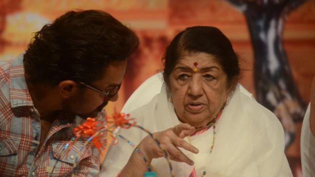 Actor Aamir Khan talks to singer Lata Mangeshkar during Dinanath Mangeshkar memorial awards. (IANS)