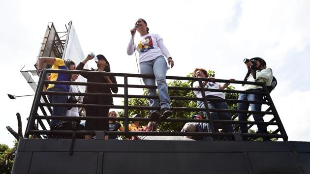Opposition ex-congresswoman Maria Corina Machado speaks to other demonstrators during the protest. The government and the opposition have traded blame for the deadly violence, with each side accusing the other of trying to mount a “coup.” (Juan Barreto/AFP) Opposition ex-congresswoman Maria Corina Machado speaks to other demonstrators during the protest. The government and the opposition have traded blame for the deadly violence, with each side accusing the other of trying to mount a “coup.” (Juan Barreto/AFP)