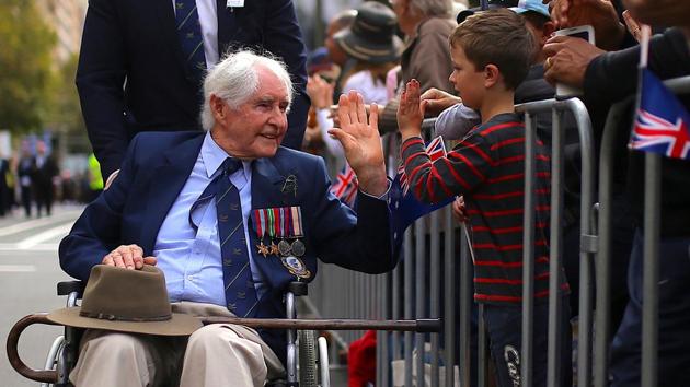 A boy greets a veteran in a wheelchair during the annual ANZAC Day march. Gallipoli was the first time that soldiers from Australia and New Zealand fought under their own flags and is seared in the national consciousness as a point where their nations came of age, emerging from the shadow of the British Empire. (Steven Saphore/REUTERS)