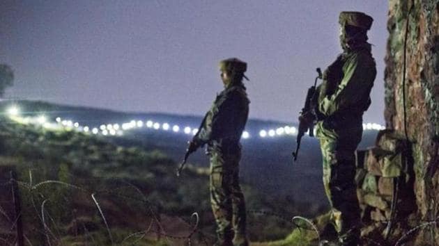 In this file photo, Indian Army soldiers are seen at a post before the illuminated fence in Hamirpur area near Bhimber Gali, about 180km northwest of Jammu. The joint doctrine of the armed forces was released on April 25.(HT file)