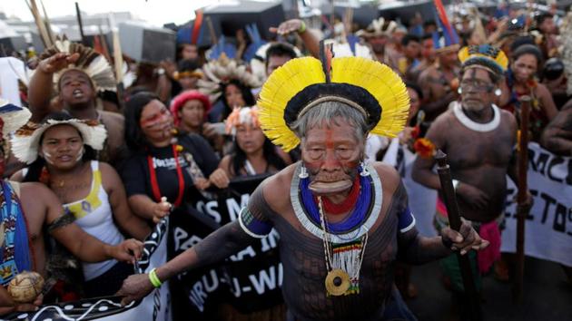 Brazilian Indians take part in a demonstration against the violation of indigenous people's rights, in Brasilia, Brazil. Brazilian military police in front of Congress hurled tear gas at thousands of indigenous protesters, who responded by throwing spears and shooting arrows as a peaceful demonstration turned into chaos. (Ueslei Marcelino/REUTERS)