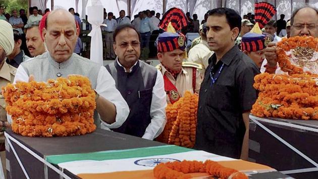 Union home minister Rajnath Singh pays tribute to CRPF jawans killed in a Maoist attack in Chhattisgarh's Sukma district, in Raipur on Tuesday.(PTI)