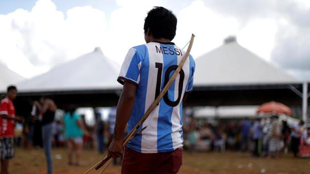 A Brazilian Indian seen wearing Lionel Messi jersey as he takes part in a demonstration. (Ueslei Marcelino/REUTERS)
