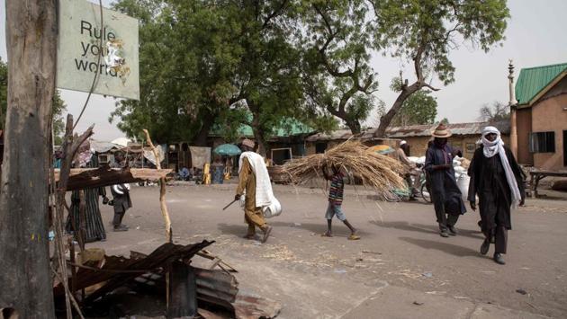 People walk on a street in the town of Damasak where Boko Haram enforced its own, radical version of Islam that forbids Western education and seeks to destroy the secular Nigerian state. (Florian Plaucheur / AFP)