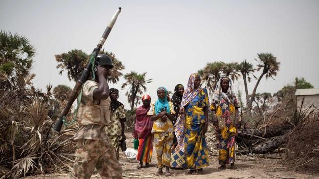 A Nigerian soldier, with a rocket propelled grenade (RPG), patrols on the outskirt of the town of Damasak . (Florian Plaucheur / AFP)