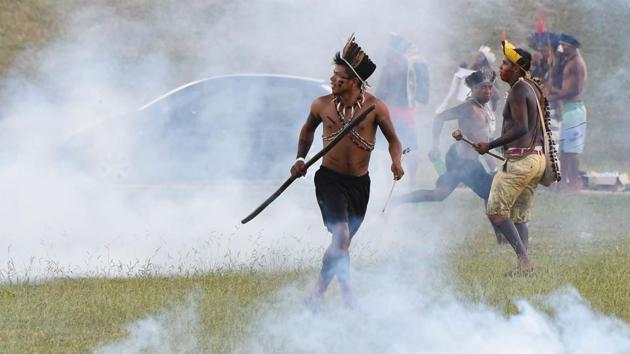 Brazilian Indians from diverse ethnic groups clash with police during their annual march for their rights. There were no reports of any injuries on either side. Police said protesters got too close to a large fountain of water on the esplanade in front of Congress in Brasilia, Brazil’s capital. (Evaristo SA/AFP)