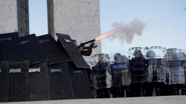Riot police fire tear gas toward brazilian Indians. It focused on legislation that would give the last word on deciding land boundaries for indigenous reservations to Congress, where a powerful farm lobby holds sway. Currently, Brazil’s president retains the power to set such boundaries. (Ueslei Marcelino/REUTERS)