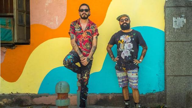 Artist duo Douglas Castro and Renato Reno of Bicicleta Sem Freio pose in front of their artwork.(Akshat Nauriyal)