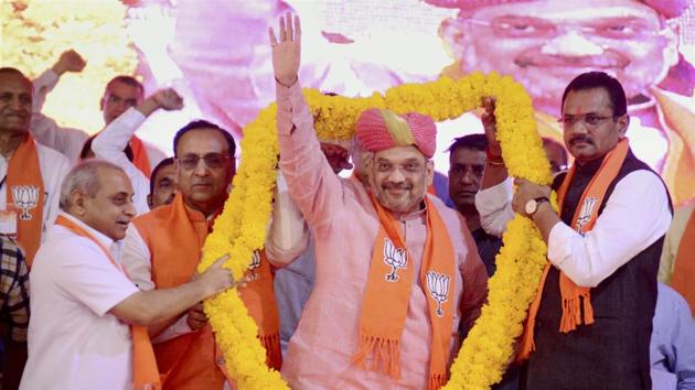 BJP national president Amit Shah being garlanded by Gujarat chief minister Vijay Rupani and deputy CM Nitin Patel at the BJP Vijay Vishwas Karyakarta Sammelan at Sabarmati riverfront in Ahmedabad, in this file photo from March 29, 2017.(PTI) BJP national president Amit Shah being garlanded by Gujarat chief minister Vijay Rupani and deputy CM Nitin Patel at the BJP Vijay Vishwas Karyakarta Sammelan at Sabarmati riverfront in Ahmedabad, in this file photo from March 29, 2017.(PTI)