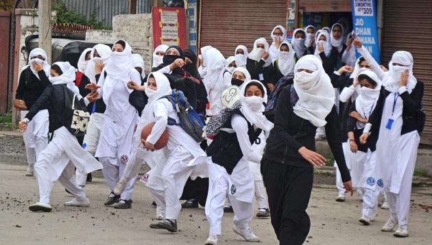 Girl students pelt stones at security personnel during clashes in the vicinity of Lal Chowk in Srinagar on April 24.(PTI Photo) Girl students pelt stones at security personnel during clashes in the vicinity of Lal Chowk in Srinagar on April 24.(PTI Photo)