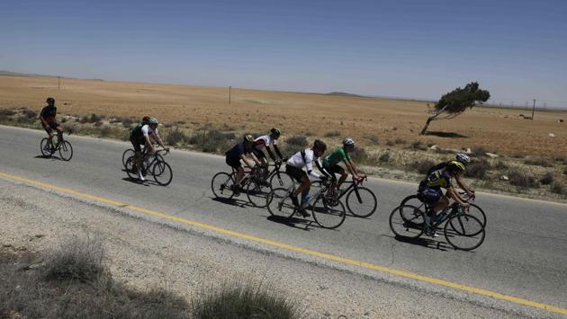 Foreign cyclists ride along a road leading to Petra during the Middle East Peace Tour. (MENAHEM KAHANA / AFP)