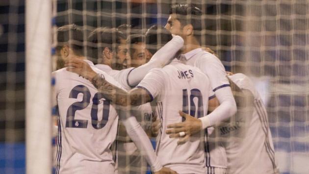 Real Madrid C.F.'s James Rodriguez (No 10) celebrates with teammates after scoring the fourth goal during their Spanish La Liga match against Deportivo La Coruna at the Riazor stadium on Wednesday.(AP)