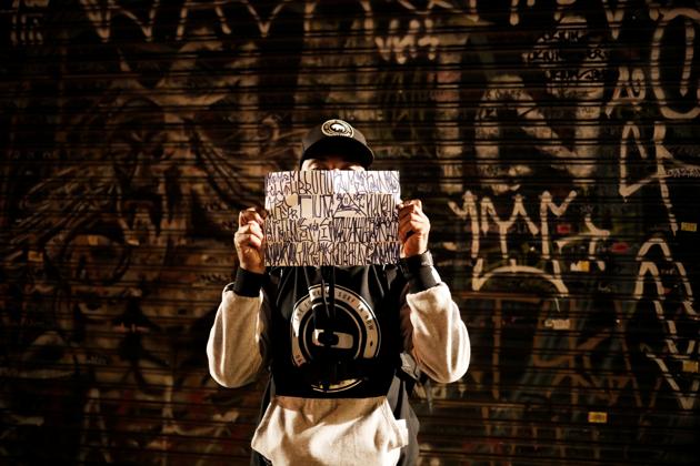 A ‘pichador’, a graffiti artist who tags buildings and landmarks with angular, runic fonts, holds a paper with personal signatures, called ‘pichacao’ during the "Dia do Point" (Meeting Point Day) in Sao Paulo, Brazil, April 20, 2017. The angular, runic font has conquered swaths of Sao Paulo’s landscape as unseen street artists scale buildings and landmarks with paint rollers and spray cans in hand, drawing the ire of many who embrace other forms of graffiti. (Nacho Doce / REUTERS)