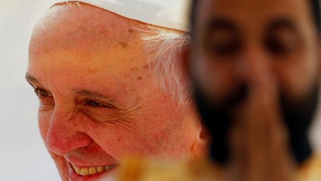 A man prays in front of an image of Pope Francis during a mass, in Cairo, Egypt .On Friday, Francis is scheduled to begin a two-day pilgrimage to Egypt aimed at lifting the spirits of Christians in the Middle East, whose numbers have rapidly dwindled in recent decades due to war, displacement and emigration. (Amr Abdallah Dalsh /REUTERS)