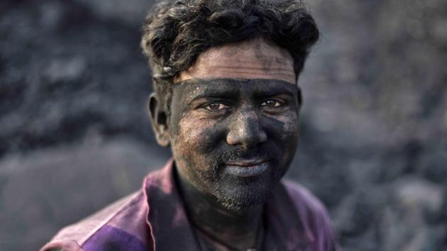 Grinding poverty drives entire families to be involved in coal scavenging as they painfully carry the heavy stones back to their houses for burning. Burning raw coal increases its volume, making it profitable to sell and becoming the only means of livelihood in Jharia and fuelling reluctance to move out, as the government doesn’t promise them an alternative livelihood once they relocate. (Ravi Choudhary/HT PHOTO)