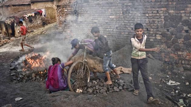 People burn coal to increase its volume in a by-lane inside Joraphatak in Dhanbad District. (Ravi Choudhary/HT PHOTO)