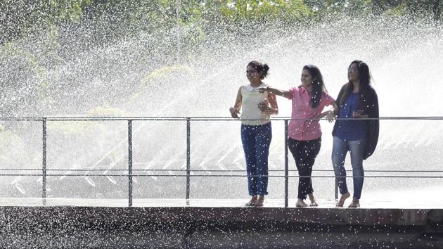 LET IT RAIN OVER ME: Sprinklers bring some much-needed respite to the girls at the PAU fountain. (Gurminder Singh/HT )