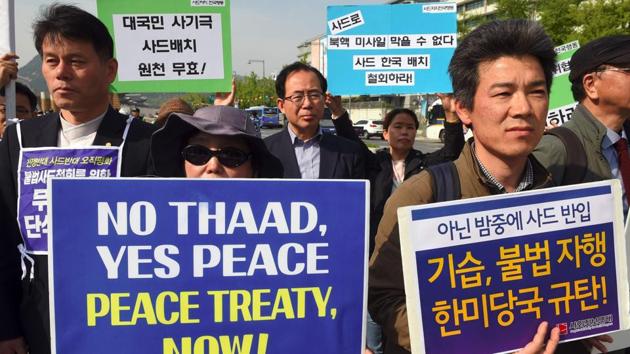 South Korean protesters hold placards during a rally against the deployment of the US Terminal High Altitude Area Defense (THAAD) system near the US embassy in Seoul on Friday.(AFP)
