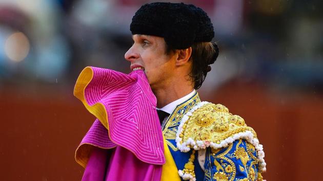 Spanish matador Julian Lopez 'El Juli' bites his capote during a bullfight. (CRISTINA QUICLER / AFP)
