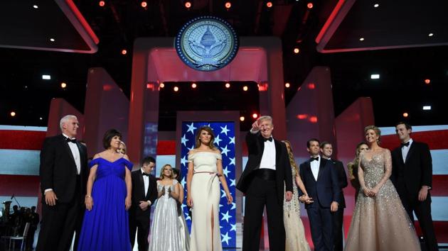 (FILES) US President Donald Trump (C) gestures as the first lady Melania Trump (center L), Vice Presidant Mike Pence (L), his wife Karen (2L) and family look on at the Liberty Ball at the Washington DC Convention Center following Donald Trump's inauguration as the 45th President of the United States, in Washington, DC, on January 20, 2017. (AFP)