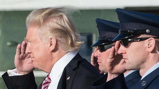 (FILES) US President Donald Trump salutes as he steps off Air Force One at Andrews Air Force Base in Maryland upon his return from Philadelphia on January 26, 2017. (AFP)