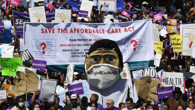 (FILES) Protesters dressed as medical staff march towards the Federal Building during a ‘Save the Affordable Care Act’ rally in Los Angeles, California on March 23, 2017. (AFP)