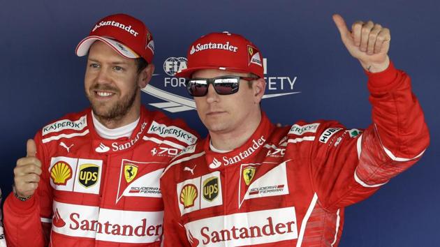 Ferrari drivers Sebastian Vettel (left) and Kimi Raikkonen (Finland) pose for photos after securing the pole and second spot respectively in qualifying for the Russian Grand Prix on Saturday.(AP)