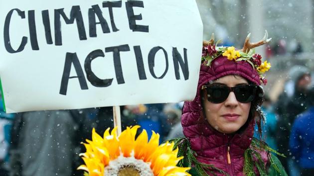 Beth Phuxster of Denver, Colorado, dressed as Mother Nature, holds a sign during the march. The Peoples Climate March, the culmination of a string of Earth Week protests that began with last Saturday’s March for Science, coincides with Trump’s 100th day in office, the end of the traditional “honeymoon” period for a new president. (Jason Connolly/AFP)