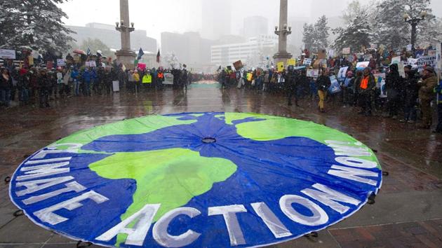 Thousands of demonstrators gather at Civic Center Park during the People's Climate March. Overseas, about three dozen events range from a protest in Vienna to a tree-planting event in Zambia. (Jason Connolly/AFP)