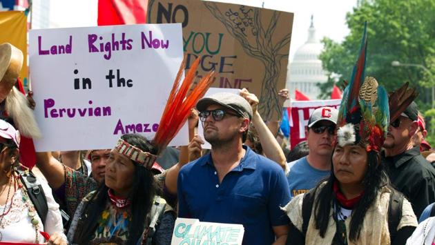 US actor Leonardo DiCaprio (2nd L) marches with a group of indigenous people from North and South America. Hollywood stars such as Leonardo DiCaprio, Jane Fonda and Kerry Washington among others came out to support the Climate March protest and urged masses to do their bit to save the environment. (Jose Luis Magana/AFP)