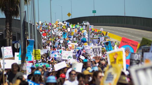 Demonstrators walk on the Pacific Coast highway. Trump’s administration is considering withdrawing from the Paris Agreement, which more than 190 countries including the United States signed in hopes of curbing global warming. (Andrew Cullen/REUTERS)