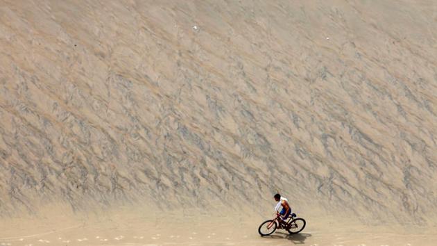 A young man rides a bike on Meireles Beach in Fortaleza, Brazil April 28, 2017. (Paulo Whitaker / REUTERS)