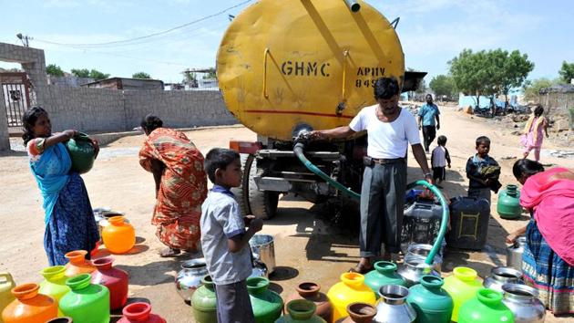 People fill plastic containers with water from a government tanker on the outskirts of Hyderabad.(AFP File Photo)