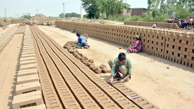 Labourers working at a brick-kiln at Bhullar village, around 35 km from Amritsar. (Sameer Sehgal/HT Photo) Labourers working at a brick-kiln at Bhullar village, around 35 km from Amritsar. (Sameer Sehgal/HT Photo)