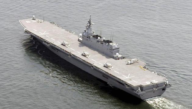 Japan's helicopter carrier JS Izumo sails by a US supply ship at anchor in the waters off Yokosuka after the Japanese destroyer departed Yokosuka port, south of Tokyo on Monday. (AP) Japan's helicopter carrier JS Izumo sails by a US supply ship at anchor in the waters off Yokosuka after the Japanese destroyer departed Yokosuka port, south of Tokyo on Monday. (AP)