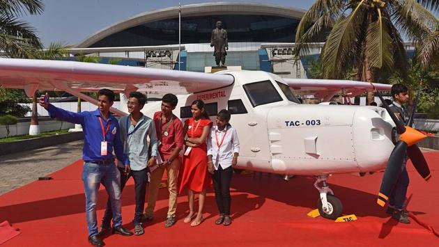 Visitors pose with an exhibit at the event on Monday, (Pratham Gokhale/HT Photo)