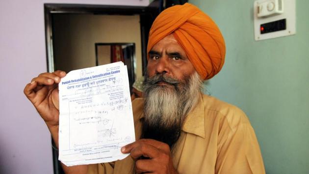 Hardeep Singh showing the de-addiction treatment slip of his son at their house in Jangpur village(Anil Dayal/HT Photo) Hardeep Singh showing the de-addiction treatment slip of his son at their house in Jangpur village(Anil Dayal/HT Photo)